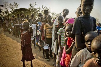 South Sudanese refugees waiting in line to get food at the Dzaipi transit centre in Uganda.