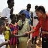 Humanitarian chief Valerie Amos (right) is greeted by children during a visit to Malakal town in Upper Nile State, South Sudan.