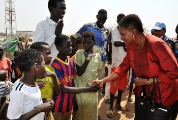 Humanitarian chief Valerie Amos (right) is greeted by children during a visit to Malakal town in Upper Nile State, South Sudan.