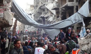 Desperate crowd awaits relief aid at Yarmouk Palestinian refugee camp in Damascus.