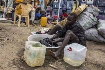 A teenager displaced by recent violence washes clothes in a basin at the compound of the UN Mission in South Sudan (UNMISS), which has become a makeshift camp for many.