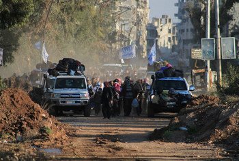 UN vehicles lead the evacuation from the Old City of Homs, Syria, during a three-day "humanitarian pause" in early February 2014.