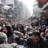 Yarmouk residents gather to await food distribution from UNRWA in January 2014.