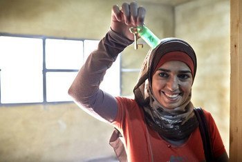 Syrian refugee Fatimah smiles while showing the key to her room at a new collective shelter in Kherbet Dawood in northern Lebanon. After fleeing the Syrian conflict with her family, she is excited to now have a room for just herself and her husband.