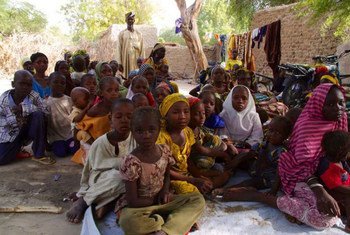 A group of refugees gather in the yard of a local man in Bosso, Niger.