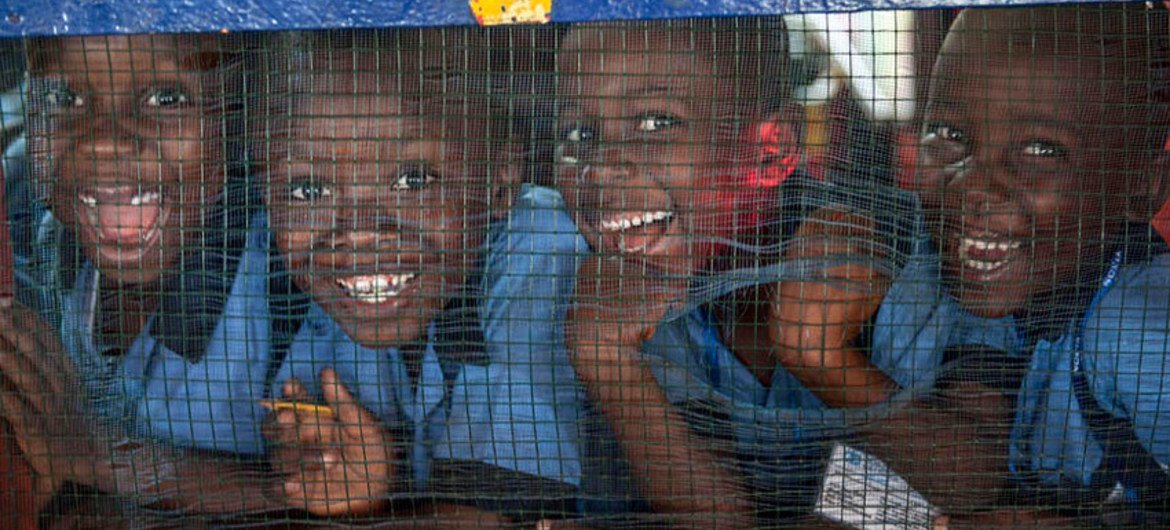 Grammar school students from the Herman Gmeiner High School in SOS Village, Matadi Estate, Monrovia, laugh at the photographer during an outreach event by UNMIL celebrating UN4U Day, in Liberia.