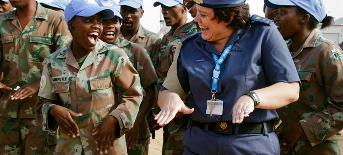 A female UN Police officer jokes around with a peacekeeping colleague at the African Union-United Nations Hybrid Operation in Darfur (UNAMID).