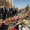 Secretary-General Ban Ki-moon (centre) pays his respects at a makeshift memorial for the victims of the recent violence in Kyiv.