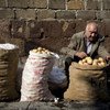 A man sells potatoes in the street outside the central market in Yerevan, Armenia.