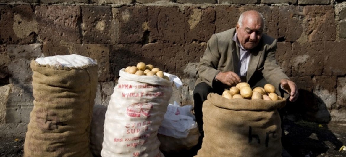 A man sells potatoes in the street outside the central market in Yerevan, Armenia.