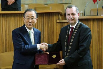 Secretary-General Ban Ki-moon (left) displays a gold medal he received at Charles University in Prague, Czech Republic, where he delivered a lecture.