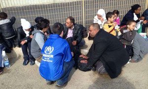 Des employés du HCR discutent avec des gens ayant traversé la Méditerranée vers l'Italie. Photo UNHCR/A. Belrhazi