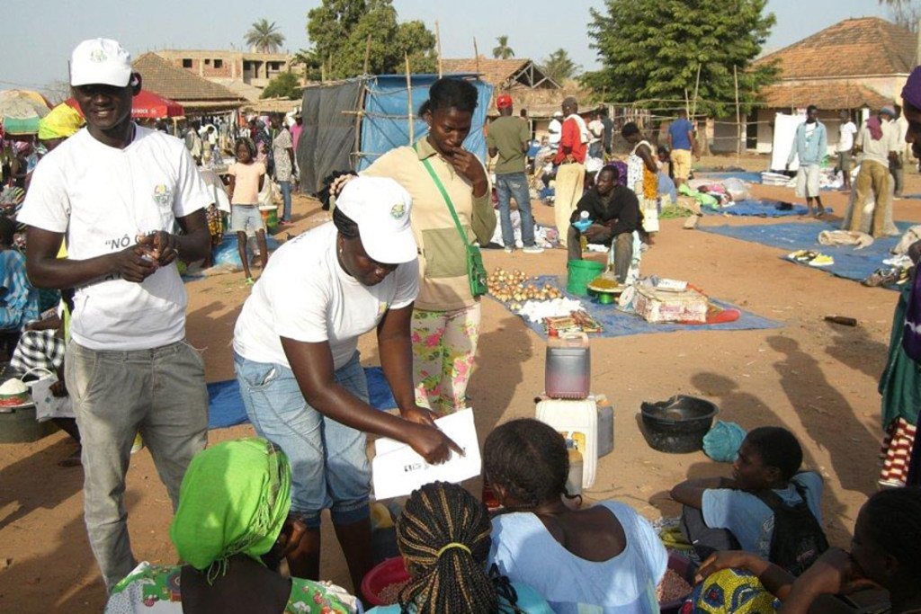 In this file photograph, taken ahead of the 2014 elections in Guinea-Bissau, civic education officials visit communities and explain voting procedures to local populations.