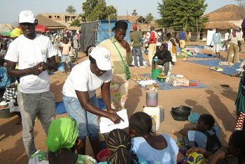 In this file photograph, taken ahead of the 2014 elections in Guinea-Bissau, civic education officials visit communities and explain voting procedures to local populations.