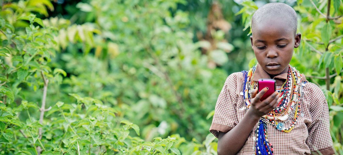 In countries where physical books are hard to come by and illiteracy rates are high, mobile technology is being used to facilitate reading and improve literacy, says UNESCO.  Shown, in Kenya, a Masai girl reads on an Android phone.