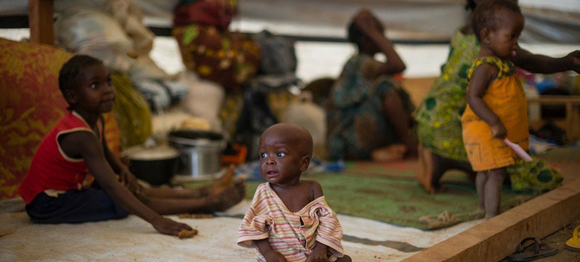 One year old Exouce, who is suffering from malnutrition, sits in a tent where he and his family are taking shelter at the Don Bosco centre in Bangui.