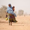 A woman and her severely malnourished son leave a UNICEF-supported health centre, in Maradi Region.