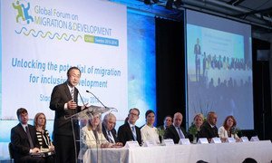 Secretary-General Ban Ki-moon (left, at lectern) addresses the opening of the Global Forum on Migration and Development in Stockholm, Sweden.