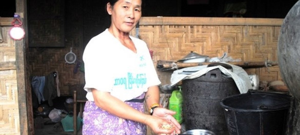 A Kachin woman prepares dinner outside her home at an IDP camp outside Myitkyina in Myanmar's northern Kachin State.