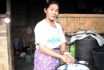 A Kachin woman prepares dinner outside her home at an IDP camp outside Myitkyina in Myanmar's northern Kachin State.
