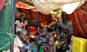 A family sitting inside a makeshift shelter at the UN compound in Malakal, Upper Nile State, South Sudan.