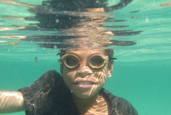 Young Timorese fisherman wearing his wooden goggles to catch fish along the shores of Atauro island off Dili.