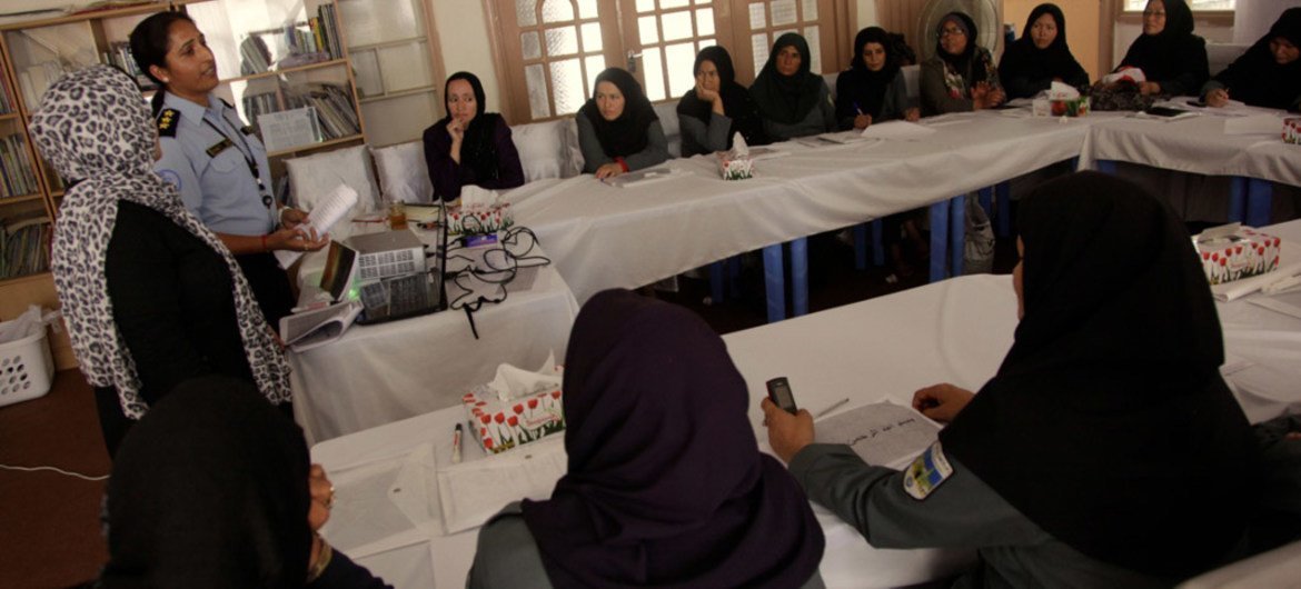 Women police in Herat, Afghanistan, boost their literacy through UNAMA’s <i>Ustad Mobile</i> programme.