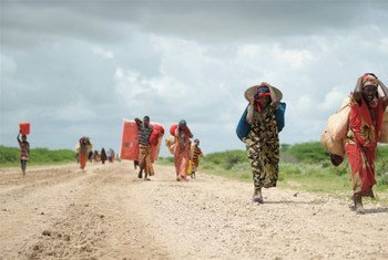Carrying whatever possessions they can, women arrive at a camp for Internally Displaced People (IDPs) established next to a base of the African Union Mission for Somalia (AMISOM) near Jowhar.