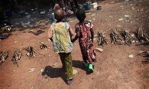 Two small children walk hand-in-hand in the Castor Church displacement camp in Bangui, the Central African Republic capital.