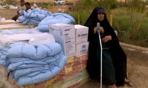 An Iraqi woman displaced by conflict in Anbar rests on a pile of UNHCR mattresses. The aid seen here was distributed shortly afterwards.