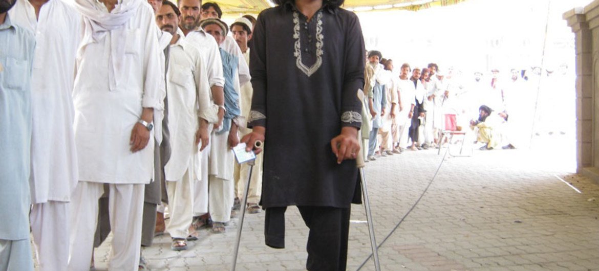Sagher Ullah stands in a queue at a WFP distribution point for internally displaced in North Waziristan, Bannu.