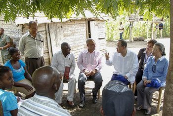 Secretary-General Ban Ki-moon (third from the right) visits with a family in Los Palmas, Haiti.