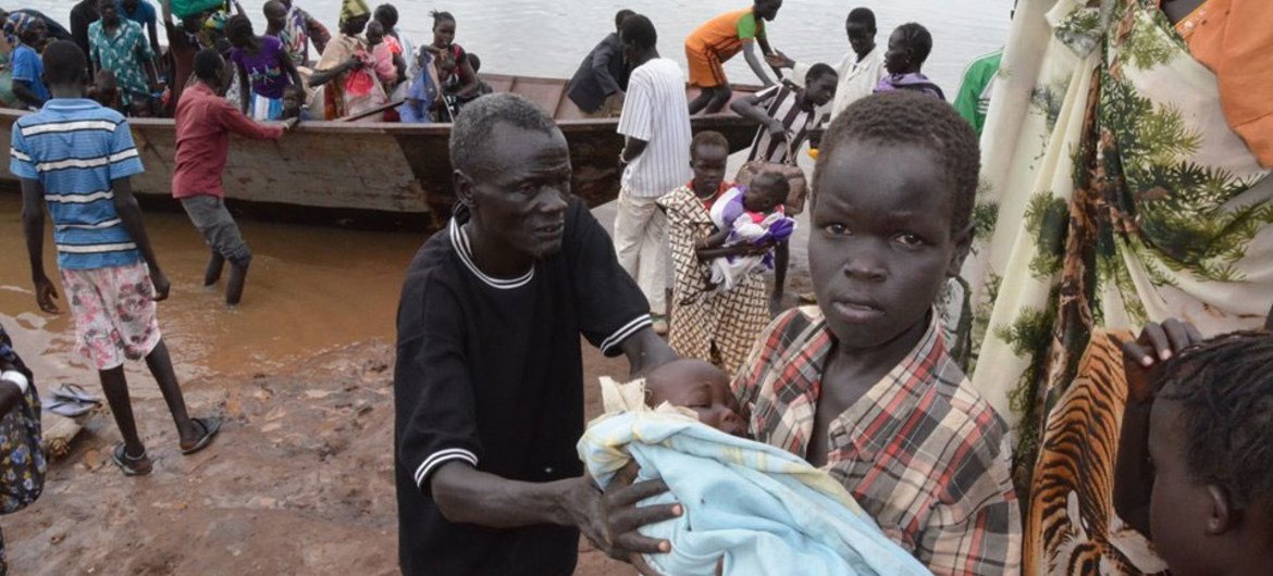 South Sudanese refugees, many of them women and children, arrive by boat in Ethiopia.