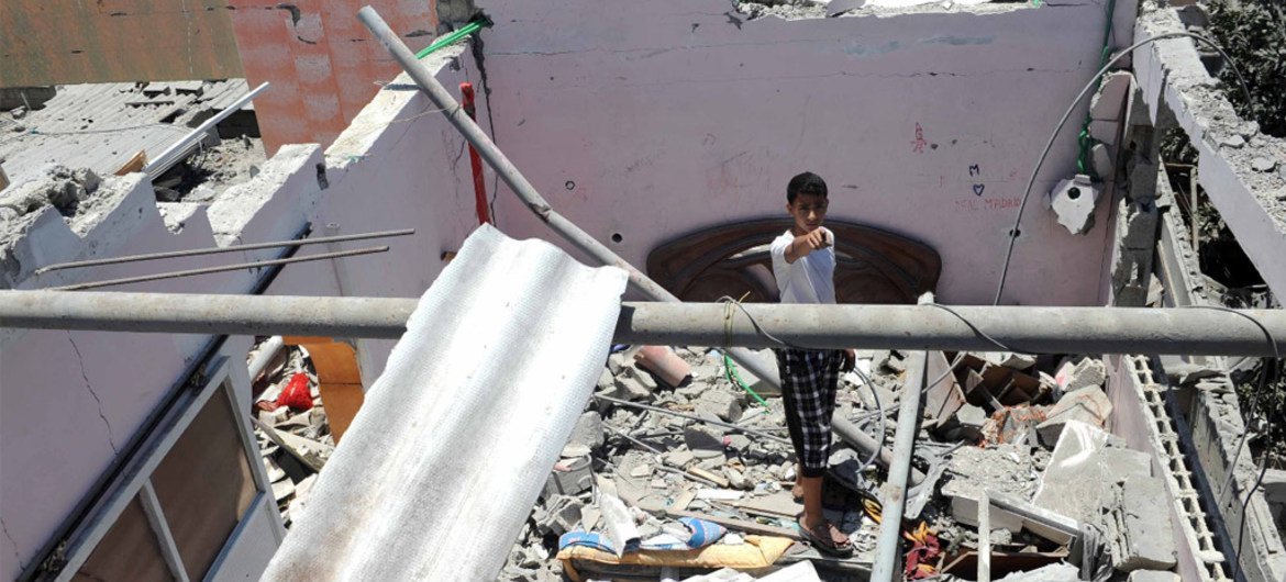 A young boy stands in the ruins of a house which was destroyed during an air strike in Central Bureij refugee camp in the Gaza Strip.