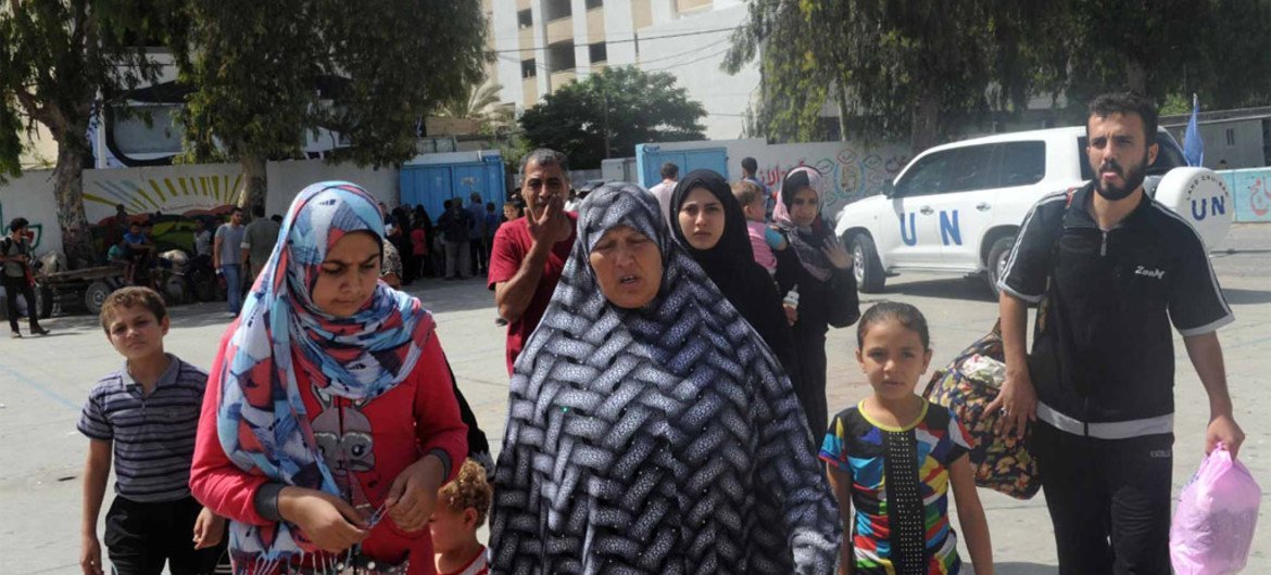 Palestinian families seek shelter at an UNRWA school after evacuating their homes north of the Gaza Strip.