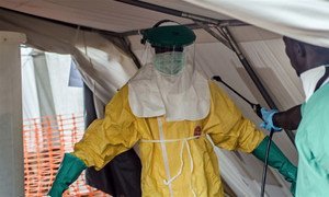 A Médecins Sans Frontières (MSF) health worker donning a protective suit to treat Ebola victims in Kailahun, Sierra Leone.