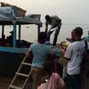 Refugees disembark from the boat that has brought them back home across the Oubangui River to the Democratic Republic of the Congo (DRC).