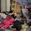 Members of an ethnic Yezidi family sleep in the shade in Shekhadi village, Iraq, after fleeing Sinjar.