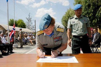 Major-General Kristin Lund signing the hand-over document with outgoing Major General Chao Liu at the UN peacekeeping force in Cyprus headquarters.