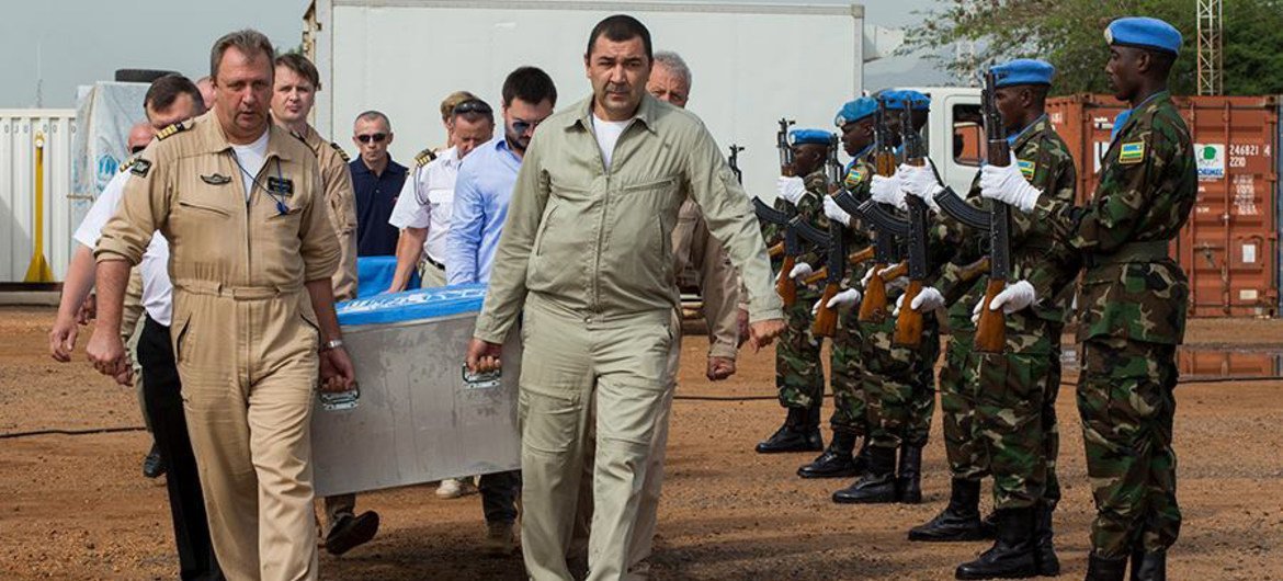 UN aircraft crew carrying the remains of three crew members to memorial service in Juba, South Sudan. They died when their helicopter came down near Bentiu, Unity State, on 26 August 2014.
