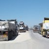 Truckloads of humanitarian aid and commercial goods bottle-necked at Kerem Shalom crossing along the Gaza-Israel border.