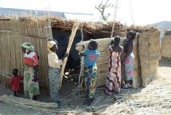 Nigerian women forced to flee their homeland work together to build a shelter at the Minawao refugee camp in Cameroon.