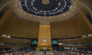 A wide view of the General Assembly Hall as President of the 69th session of the Assembly, Sam Kahamba Kutesa (on screens), makes his opening address.