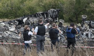 Members of the  Organization for Security and Cooperation in Europe (OSCE) Special Monitoring Mission to Ukraine examine the MH17 crash site in July 2014. Photo: OSCE/Evgeniy Maloletka