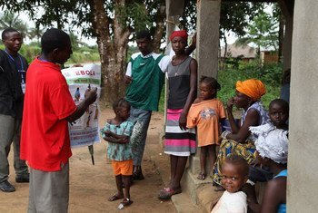 Une équipe de volontaires dans le village de Gbaneh Bana, en Sierra Leone, discute de la prévention contre Ebola avec une famille. Photo OMS/S. Gborie