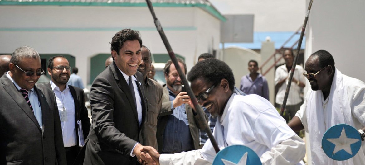 On a visit to Somalia, the Secretary-General's Envoy on Youth, Ahmed Alhendawi (second left), is greeted at the Ministry of Youth by dancers in Mogadishu.