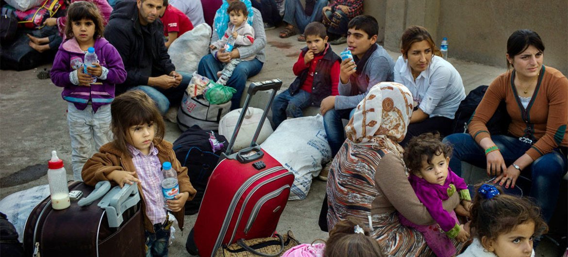 Syrian Kurds from the town of Kobane seeking shelter in Iraq's Kurdistan region.