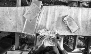 A refugee from Central African Republic checks the money she received for four people during a cash grant distribution in Mole camp, northern Democratic Republic of the Congo (DRC).