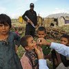 During a door-to-door national polio campaign in the Aghbarg neighbourhood of Quetta, Pakistan, a polio team vaccinate the children of a hard-to-access nomad community.