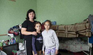 A Ukrainian mother with her daughter and young friend in the  room where she lives with her family at a centre for displaced people in Slavyansk.